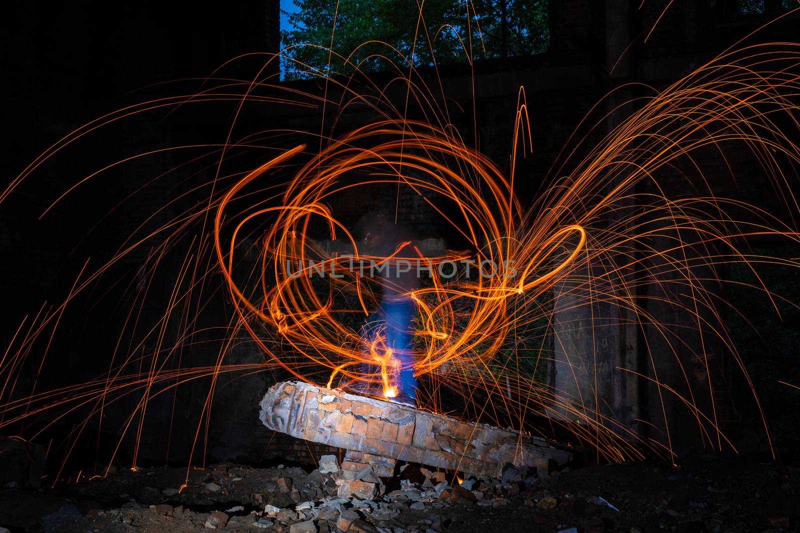 Drawing light at night in an old abandoned building, splashes of light and sparks. Freezelight