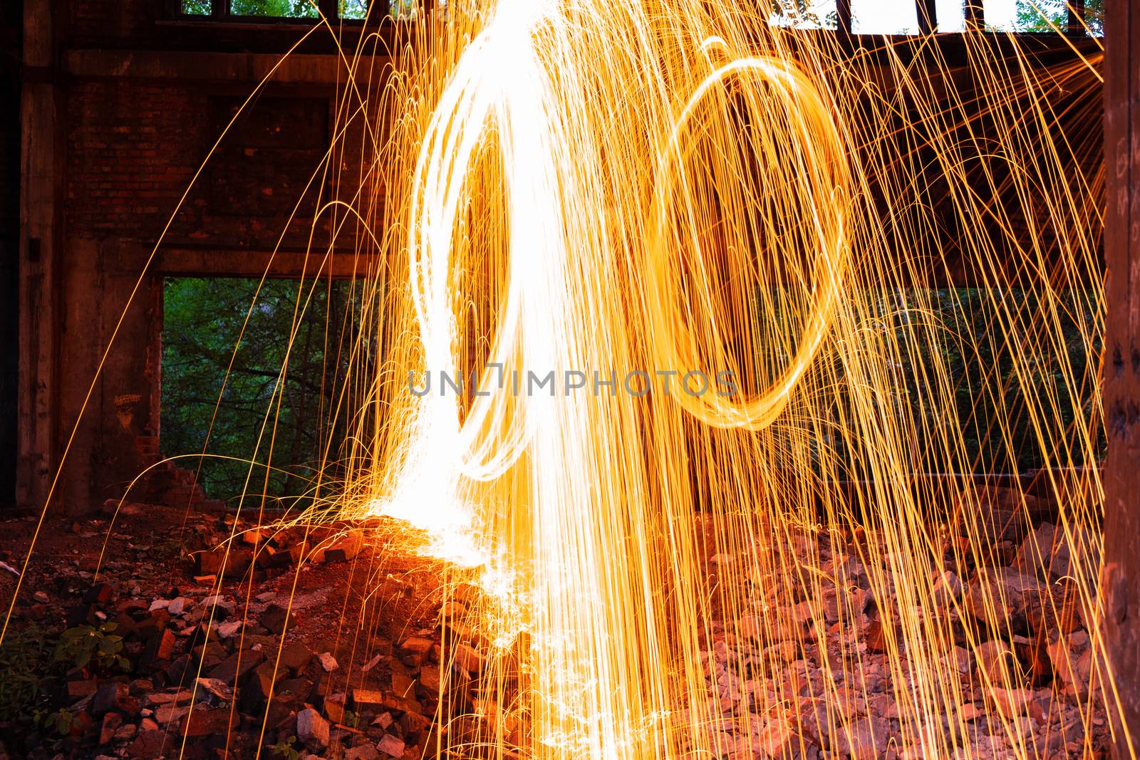 Drawing light at night in an old abandoned building, splashes of light and sparks. Freezelight