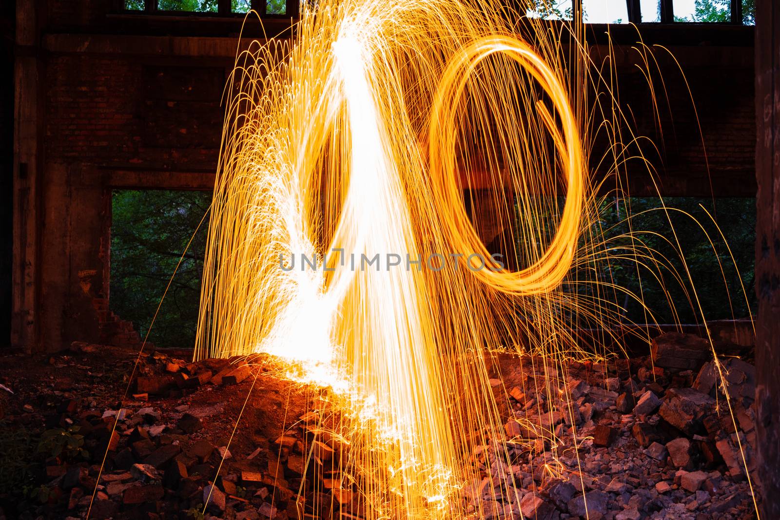 Drawing light at night in an old abandoned building, splashes of light and sparks. Freezelight