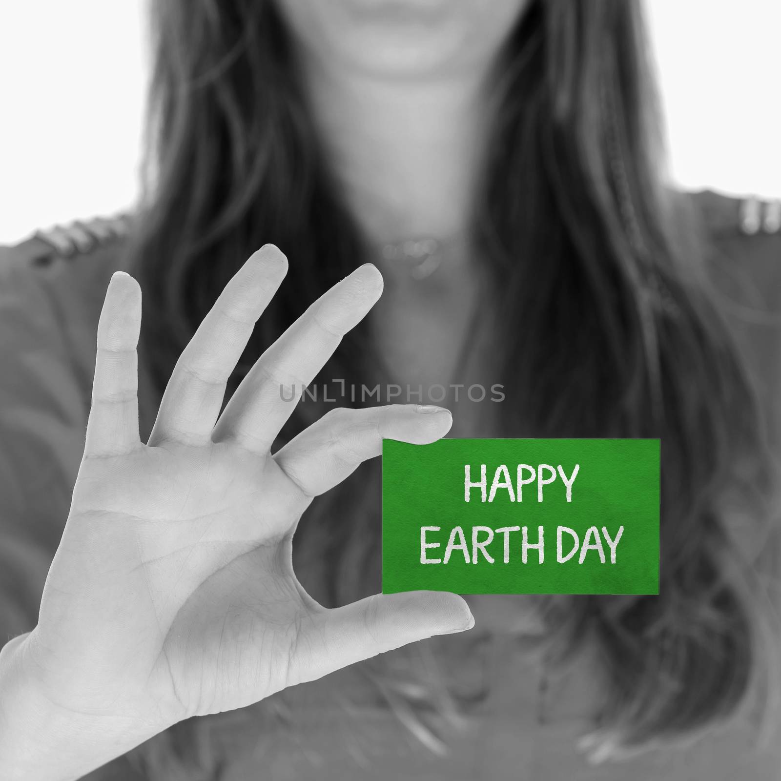 Woman showing a small message: Happy earth day