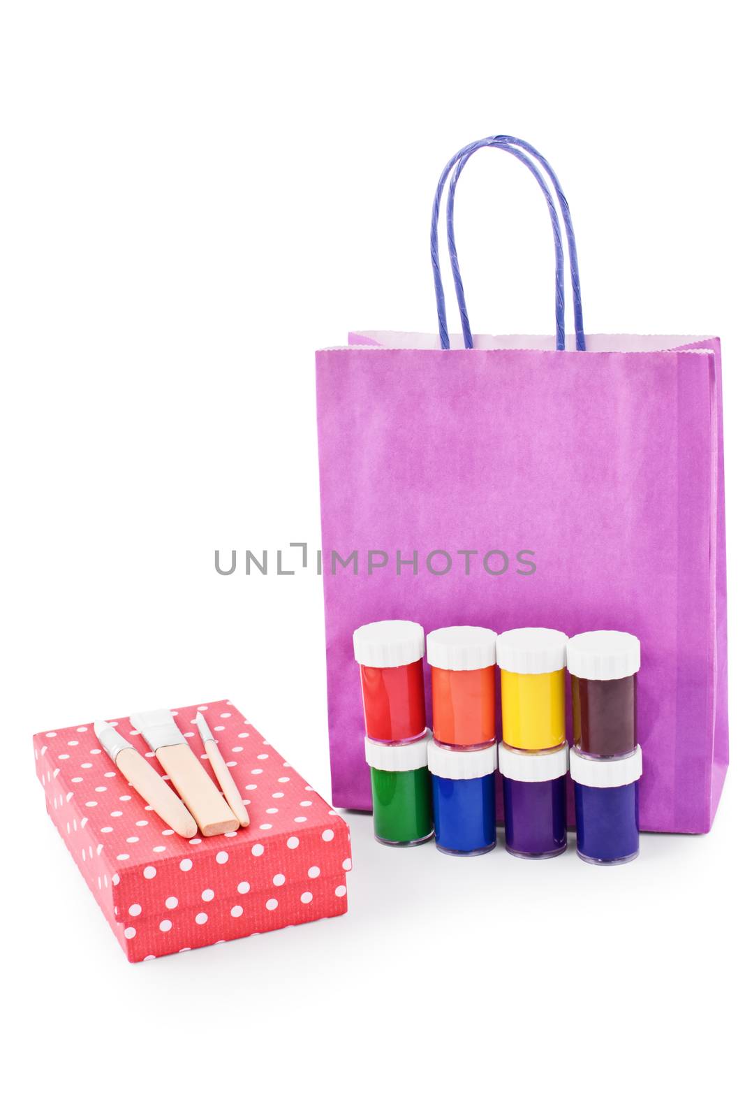 Paint brushes, paint vials, gift box and a gift bag isolated on white background.