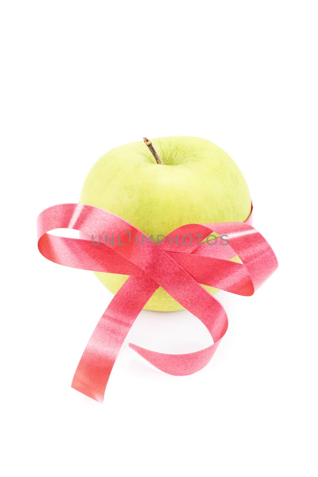 Green apple wrapped with red ribbon isolated on white background
