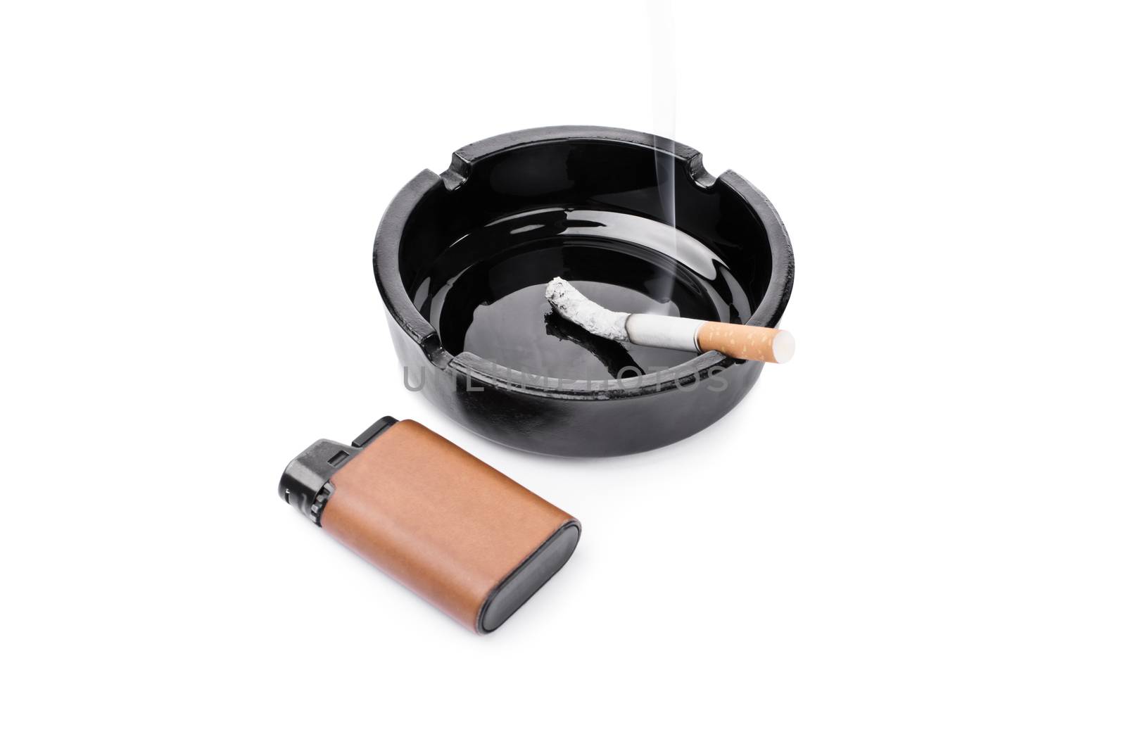 Ashtray, lighter and a smoking cigarette, isolated on white background