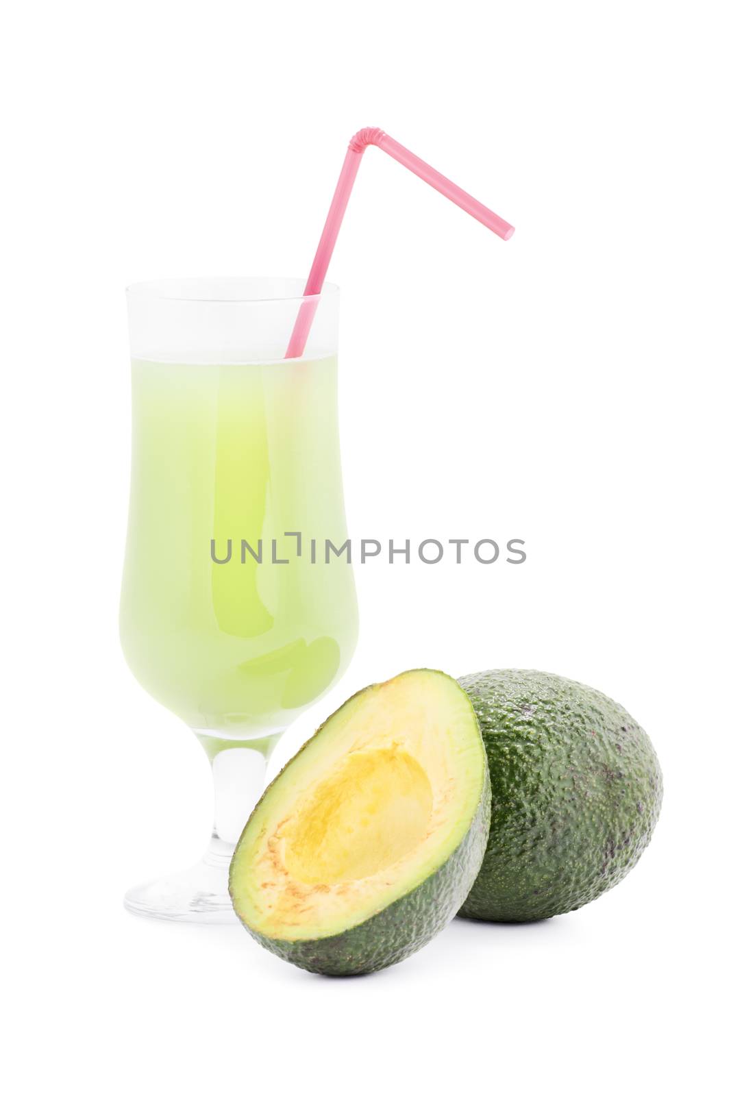 Ripe avocado and a glass of green juice next to it, isolated on white background.