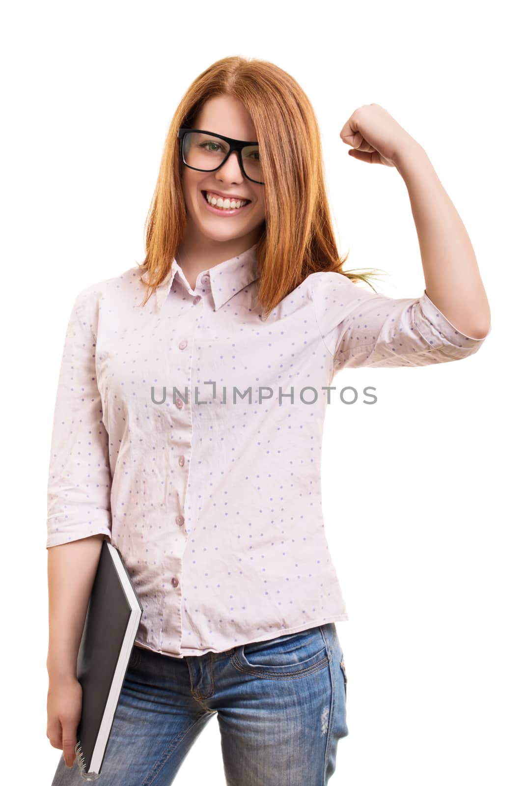A portrait of a beautiful smiling girl with glasses, holding a book and cheering because of passed exams, isolated on a white background.