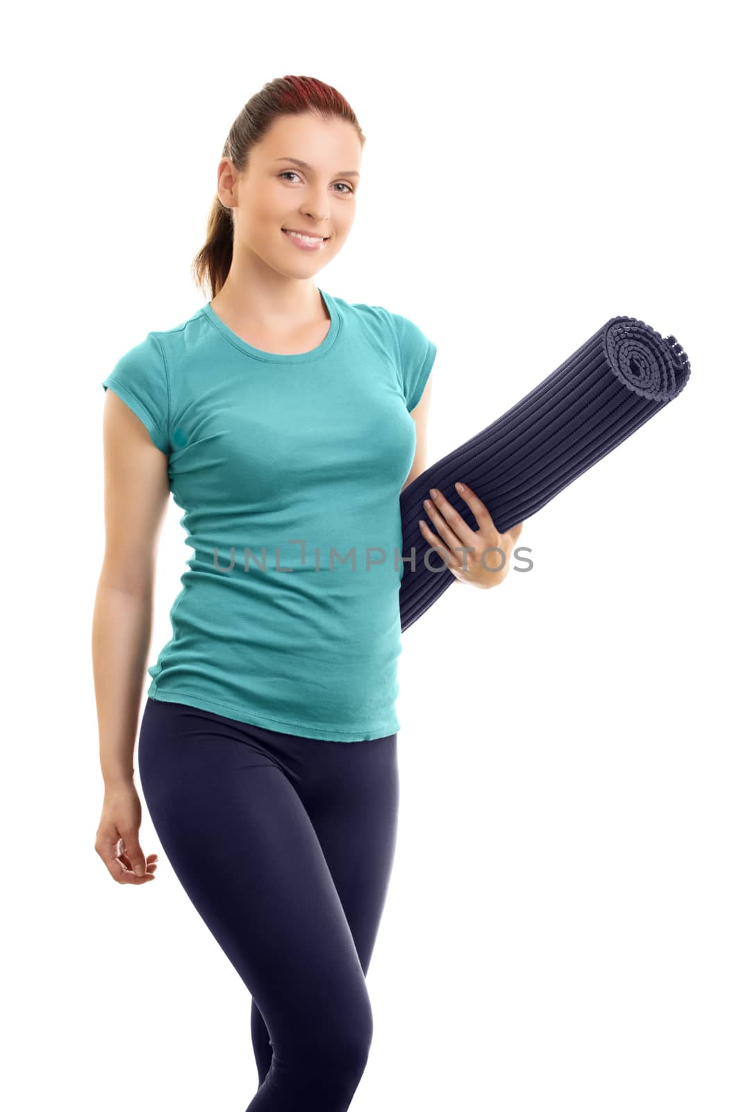 A portrait of a smiling beautiful fit girl holding a workout mat, isolated on a white background.