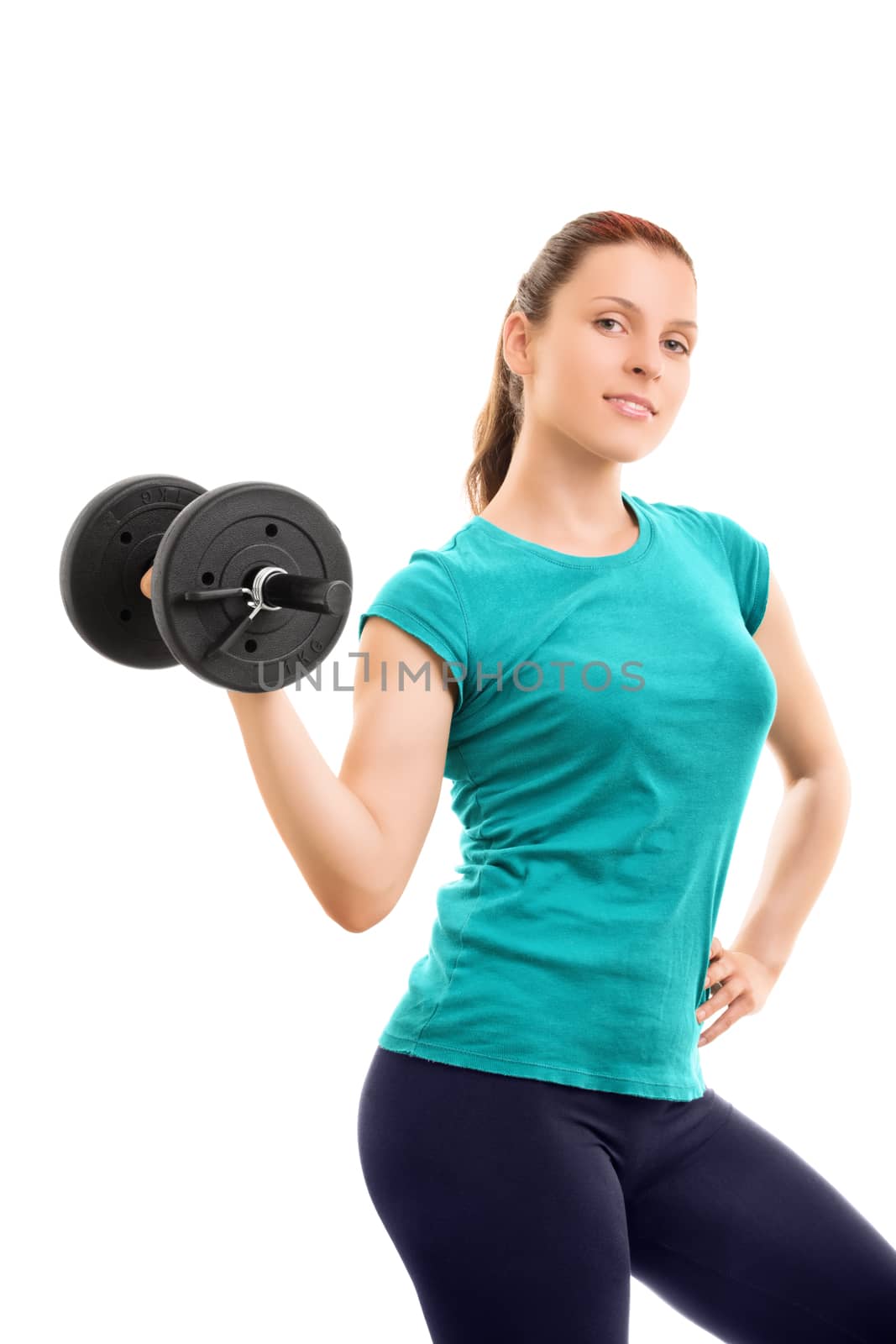 A portrait of a beautiful fit girl smiling and lifting a dumbbell, isolated on white background. Beautiful fit young girl holding a dumbbell, isolated on white background.