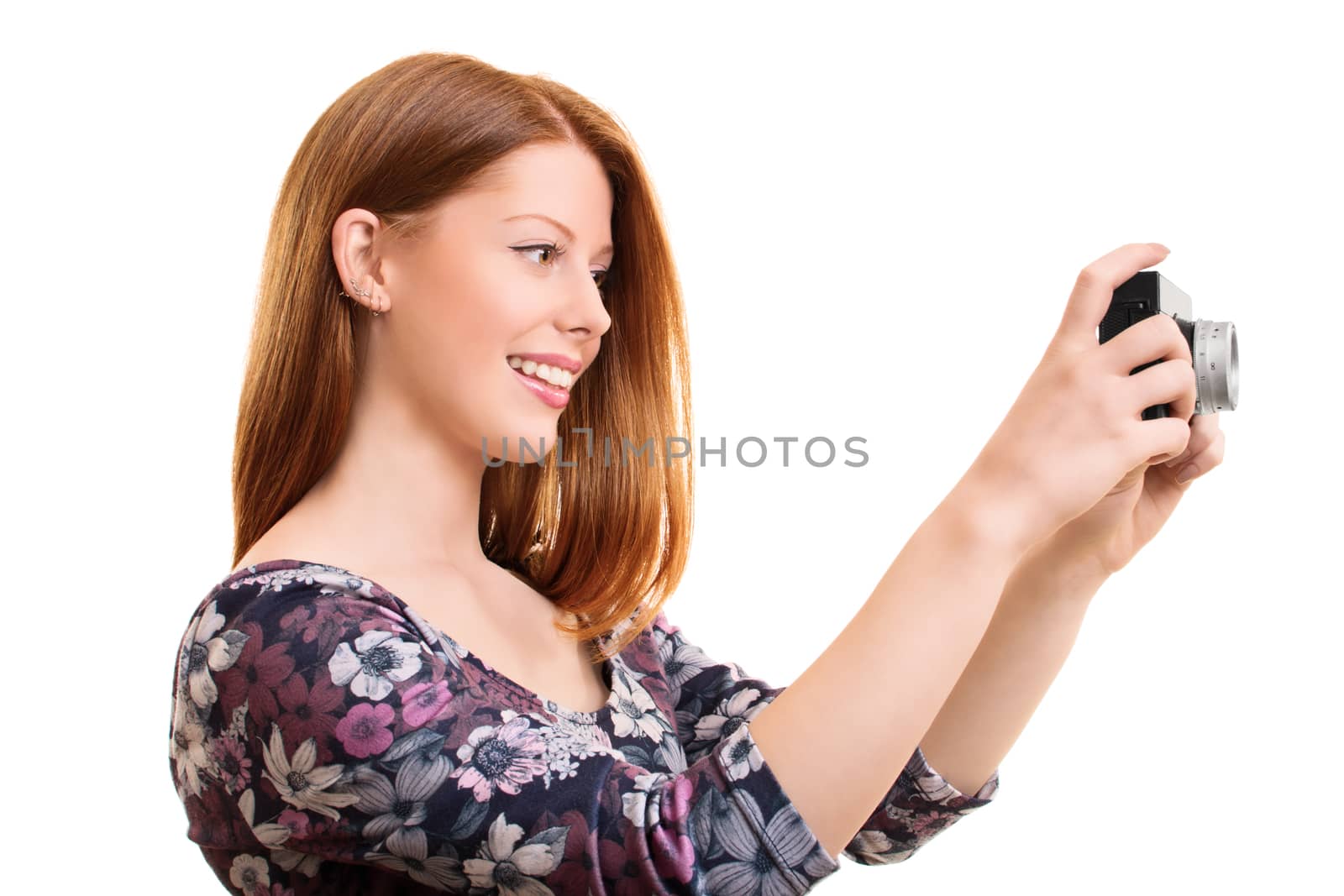 A portrait of a beautiful young girl taking a photo with a vintage camera, isolated on white background.