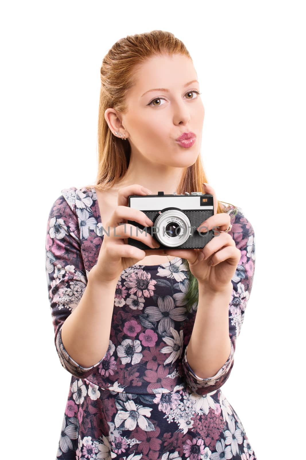A portrait of a beautiful young girl taking a picture with a vintage camera, isolated on white background.