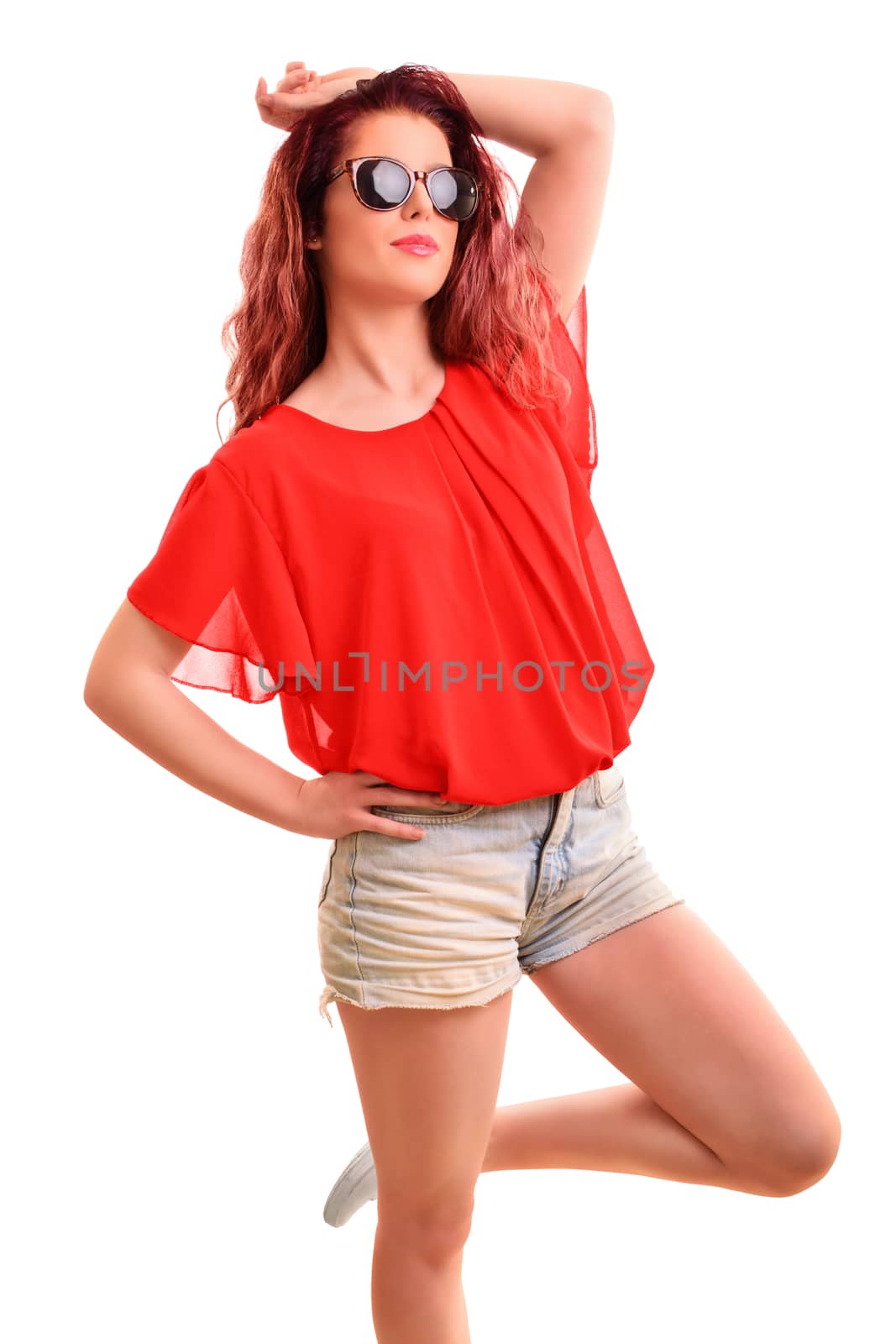 Portrait of a beautiful young girl wearing sunglasses, posing with her hand, isolated on white background.