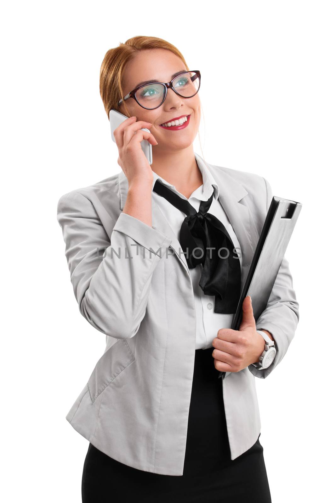 A portrait of a businesswoman talking on the phone, holding a notepad, isolated on white background.