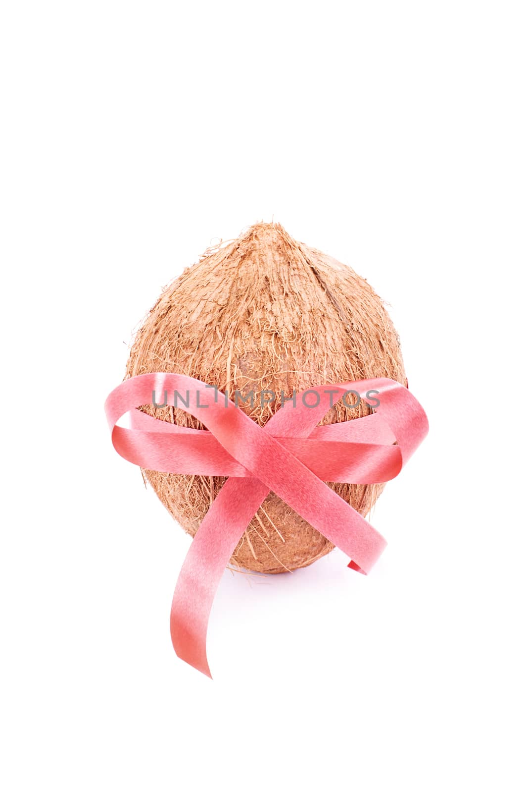 Coconut wrapped with red ribbon, isolated on white background.