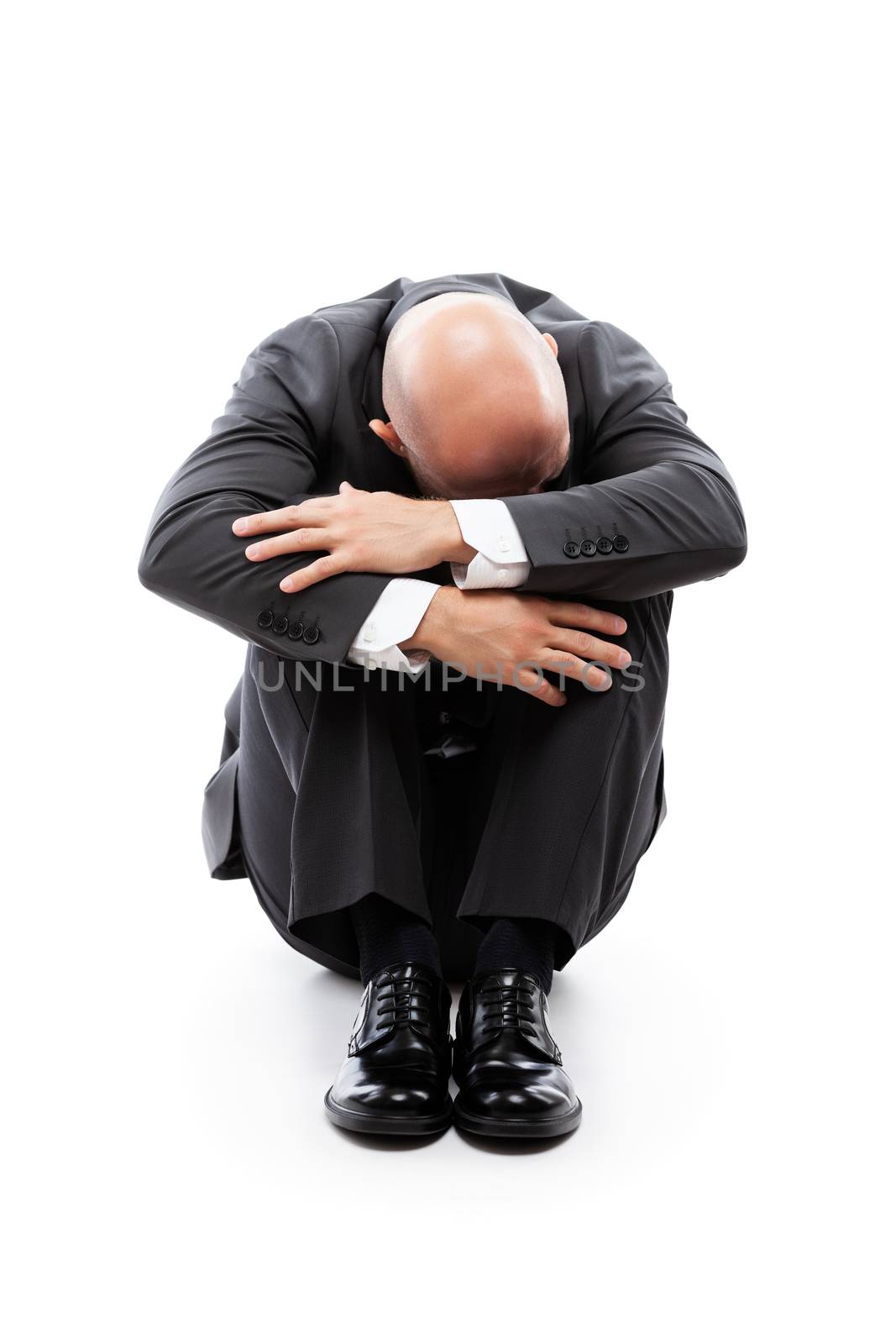 Business problems and failure at work concept - unhappy crying tired or stressed businessman sitting in depression hand hiding face white isolated