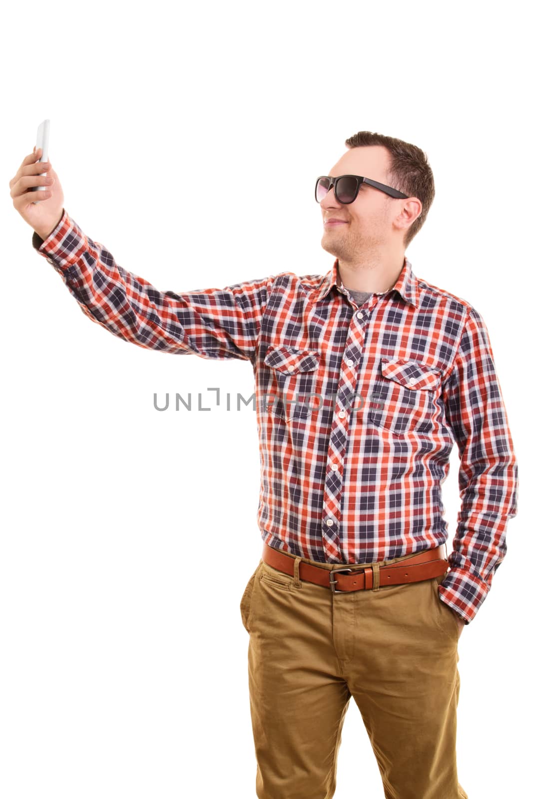 A portrait of a young fashionable man taking a selfie, isolated on white background.