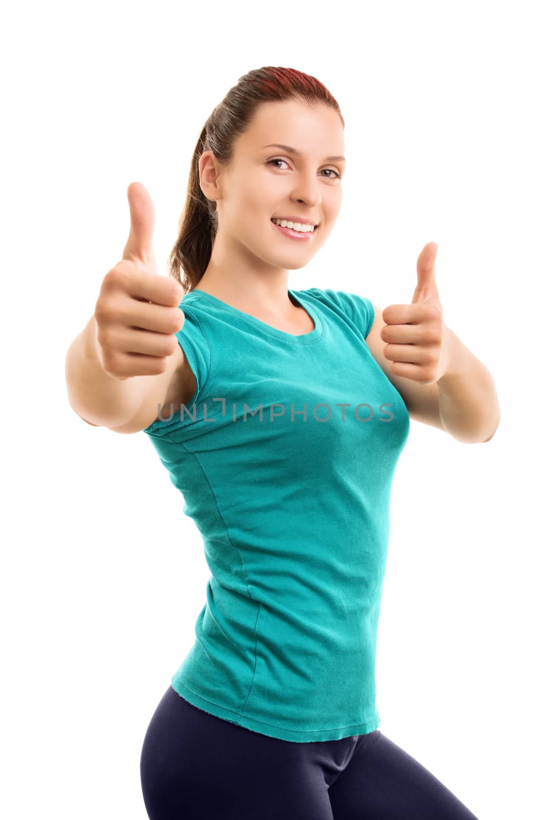 Slim and fit. You should try it. Beautiful smiling young girl in fitness clothes giving thumbs up, isolated on white background.