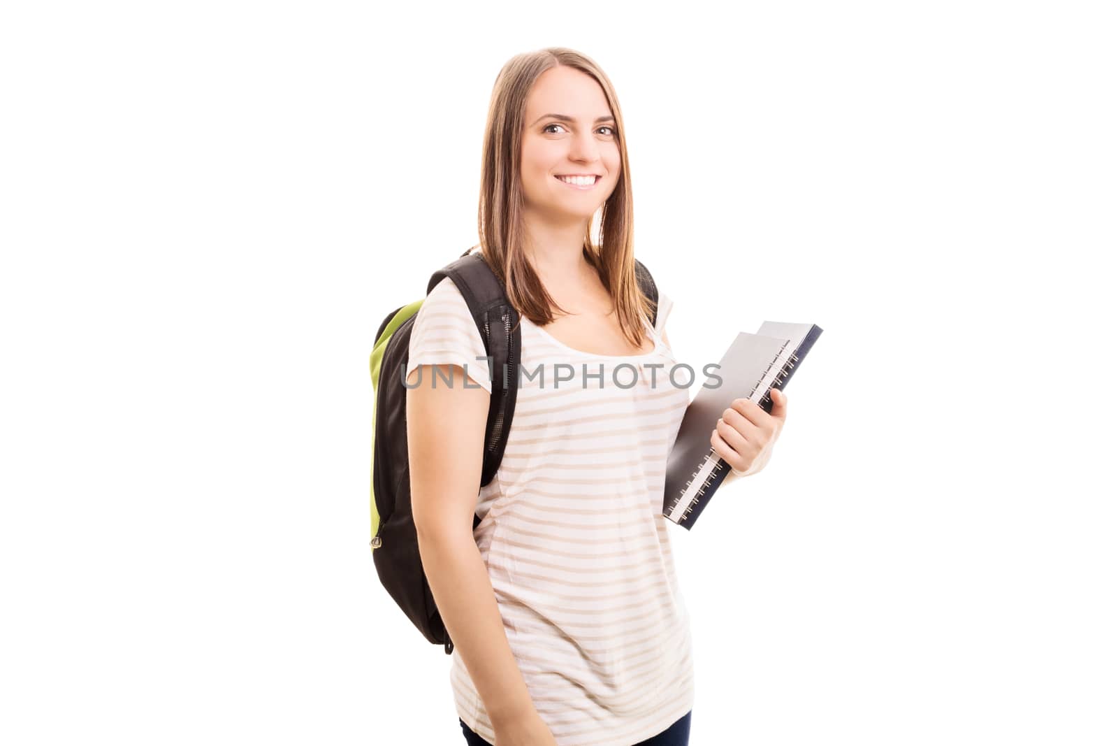 Back to school, finally! Young girl carrying a backpack, some books while going to school, isolated on white background.