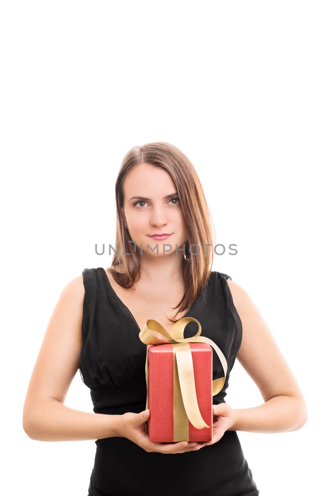 Beautiful young woman holding a lovely wrapped gift with a seductive smile, isolated on white background.