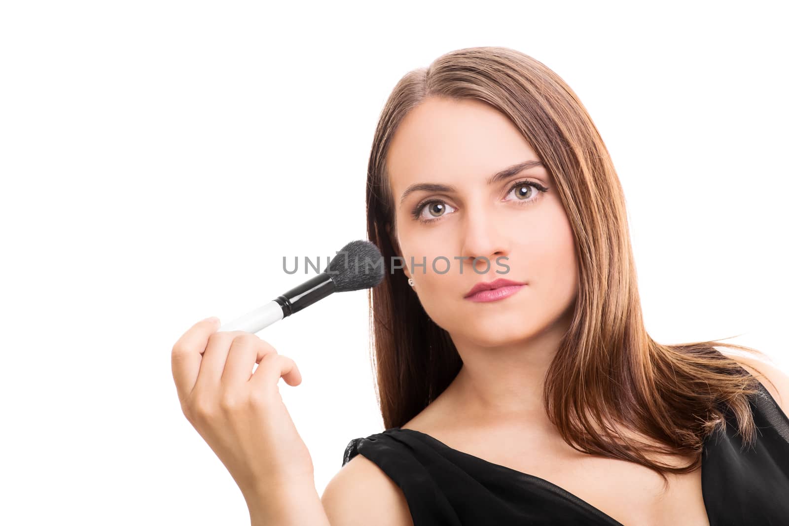 Beautiful young woman holding a make up brush isolated on white background