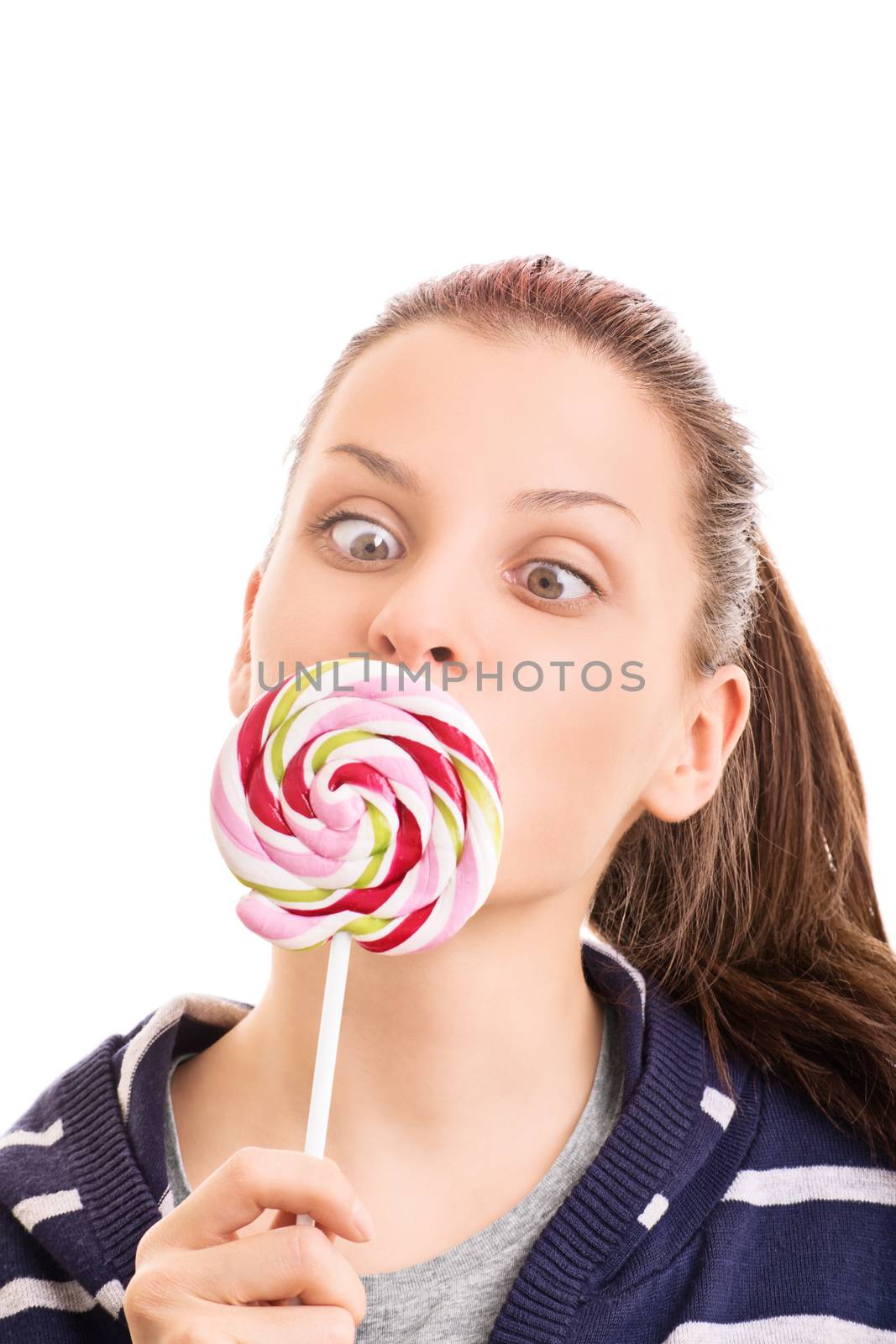Mmm, sweets, can't resist them. Beautiful young girl holding a lollipop, making funny face, isolated on white background.
