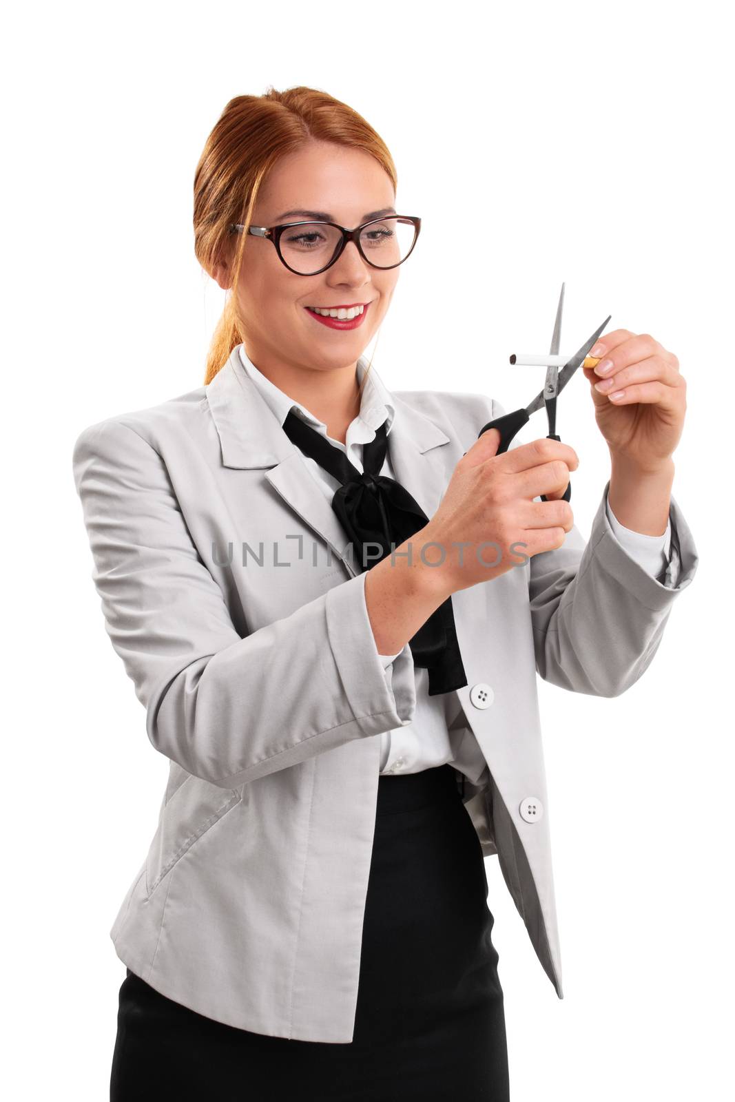 Young modern business woman cutting a cigarette with scissors, isolated on a white background.