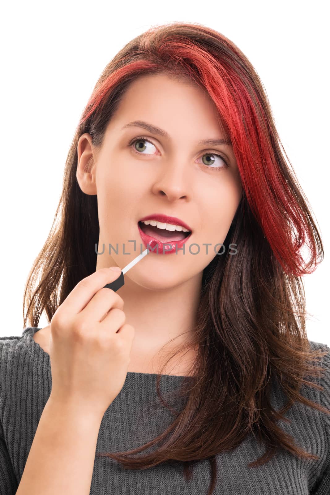 Portrait of a beautiful girl putting lipstick by Mendelex