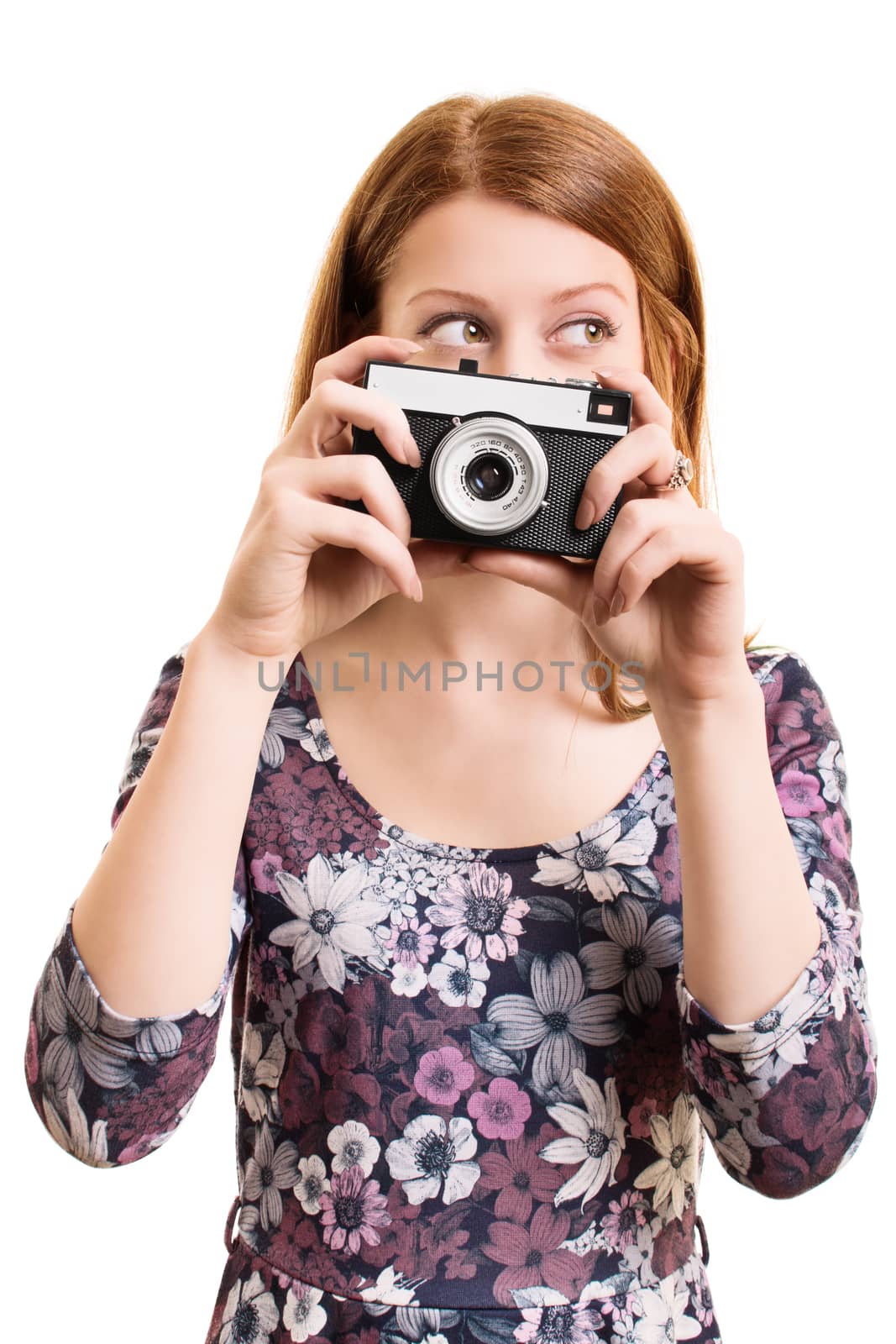 A portrait of a beautiful young girl holding a vintage camera, isolated on white background.