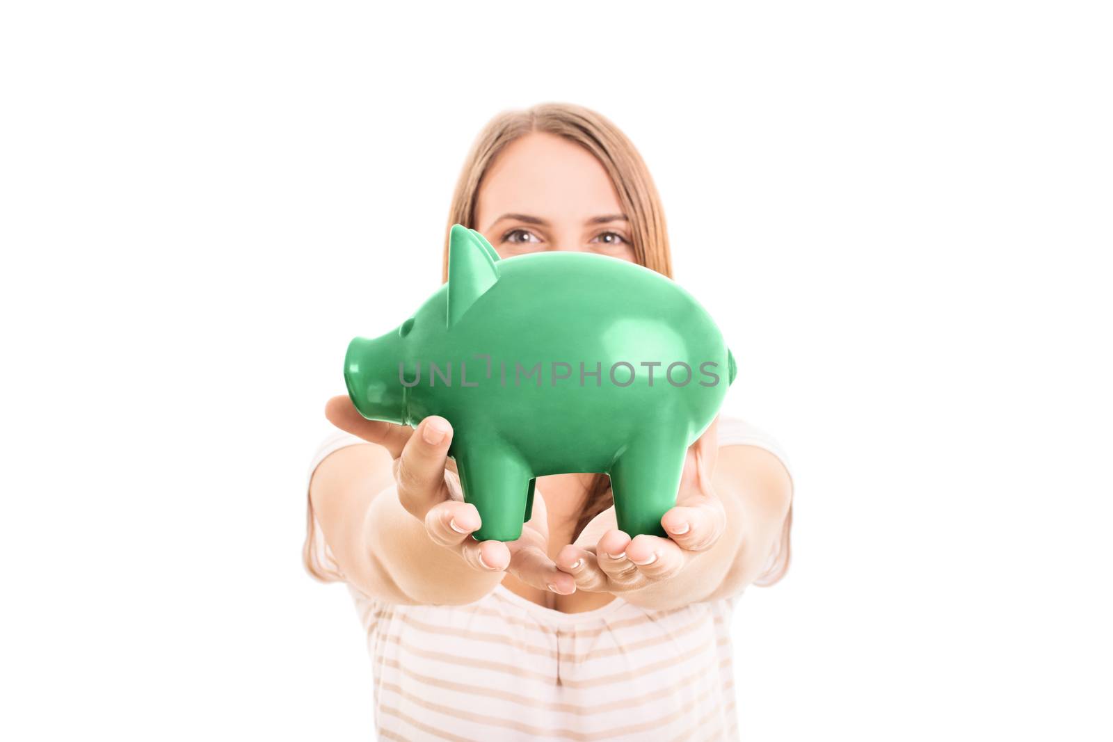 Young girl holding a piggy bank, isolated on white background.