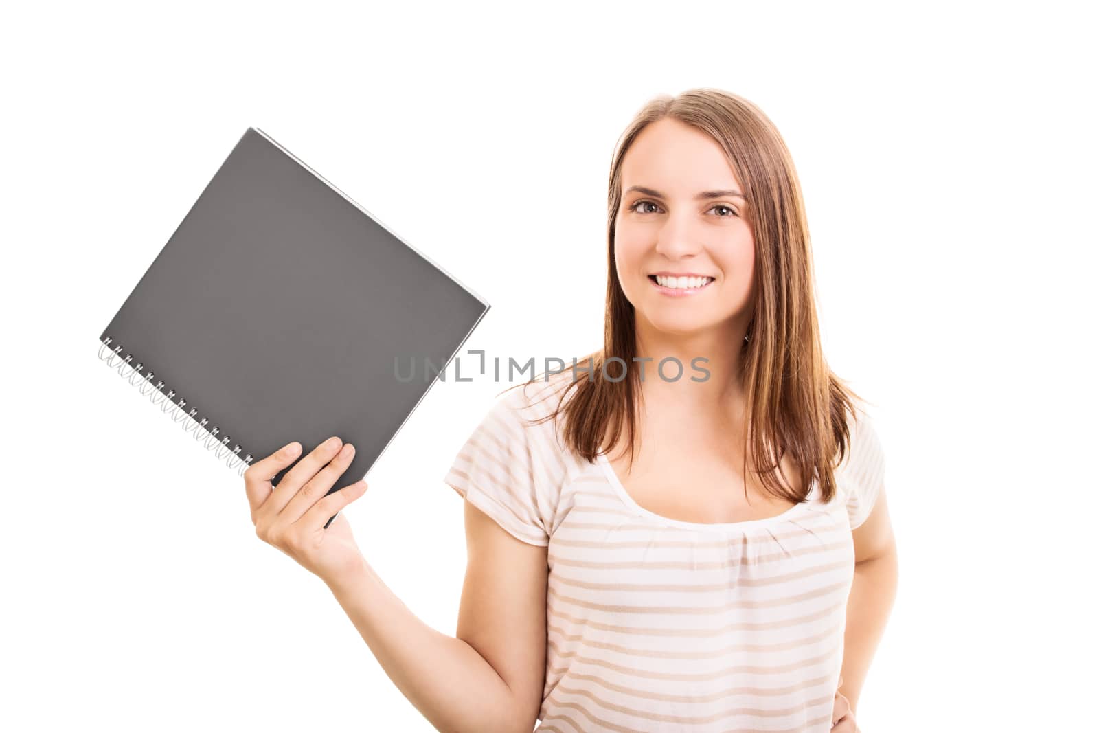 Smiling young student girl holding a notebook, isolated on white background.