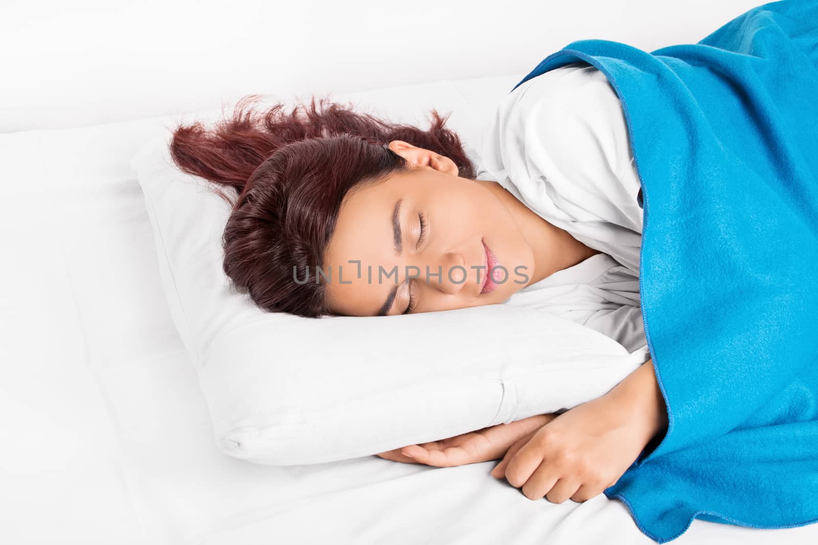 Close up shot of a beautiful young girl comfortably sleeping in bed.