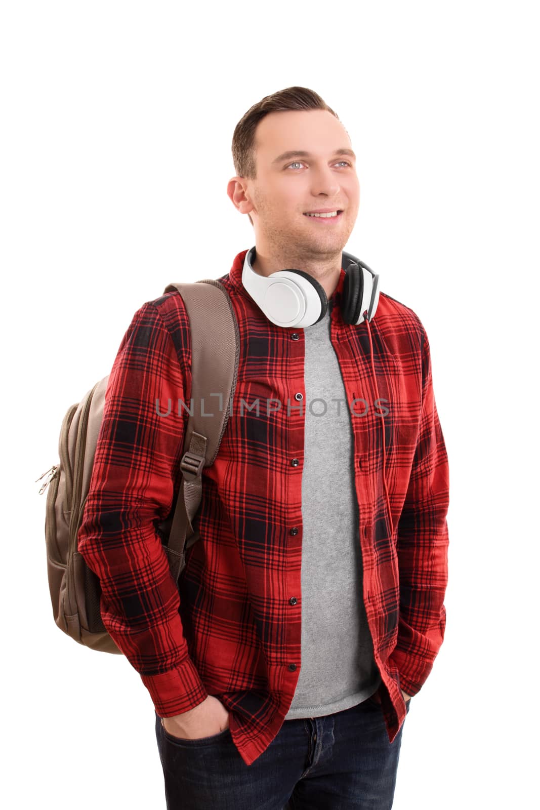 A portrait of a smiling male student, wearing a backpack and headphones, isolated on white background.