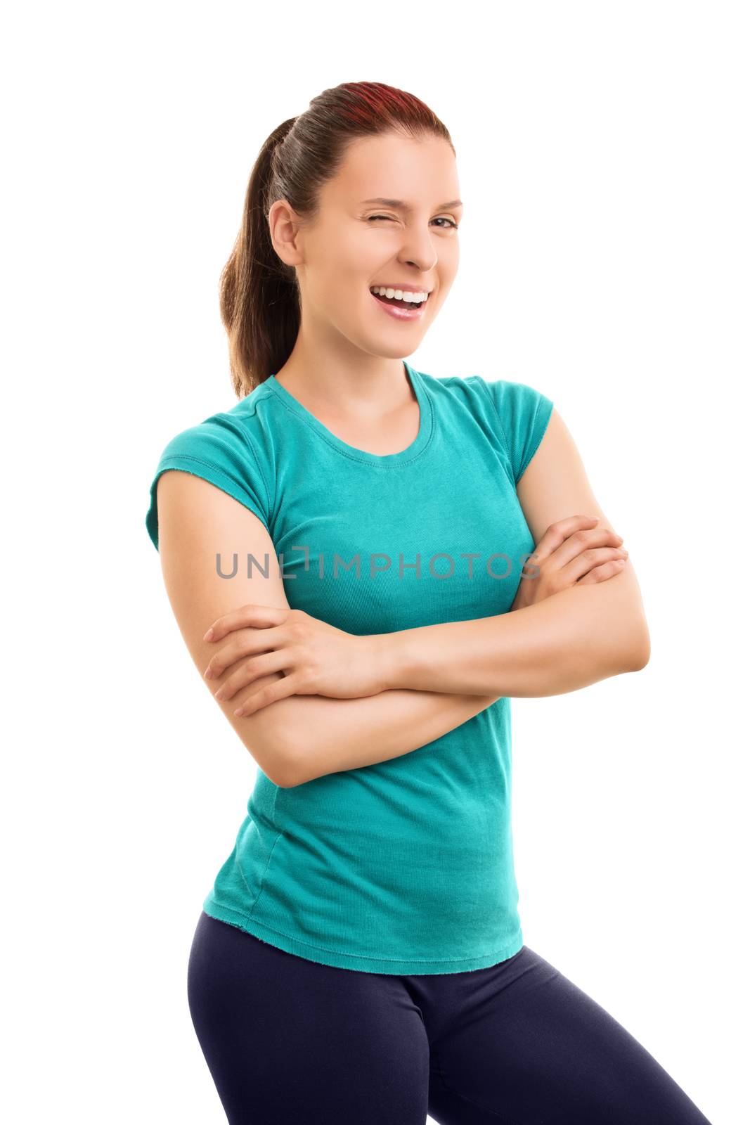 Body, mind and spirit all focused in good health. Smiling young athlete winking, isolated on white background.