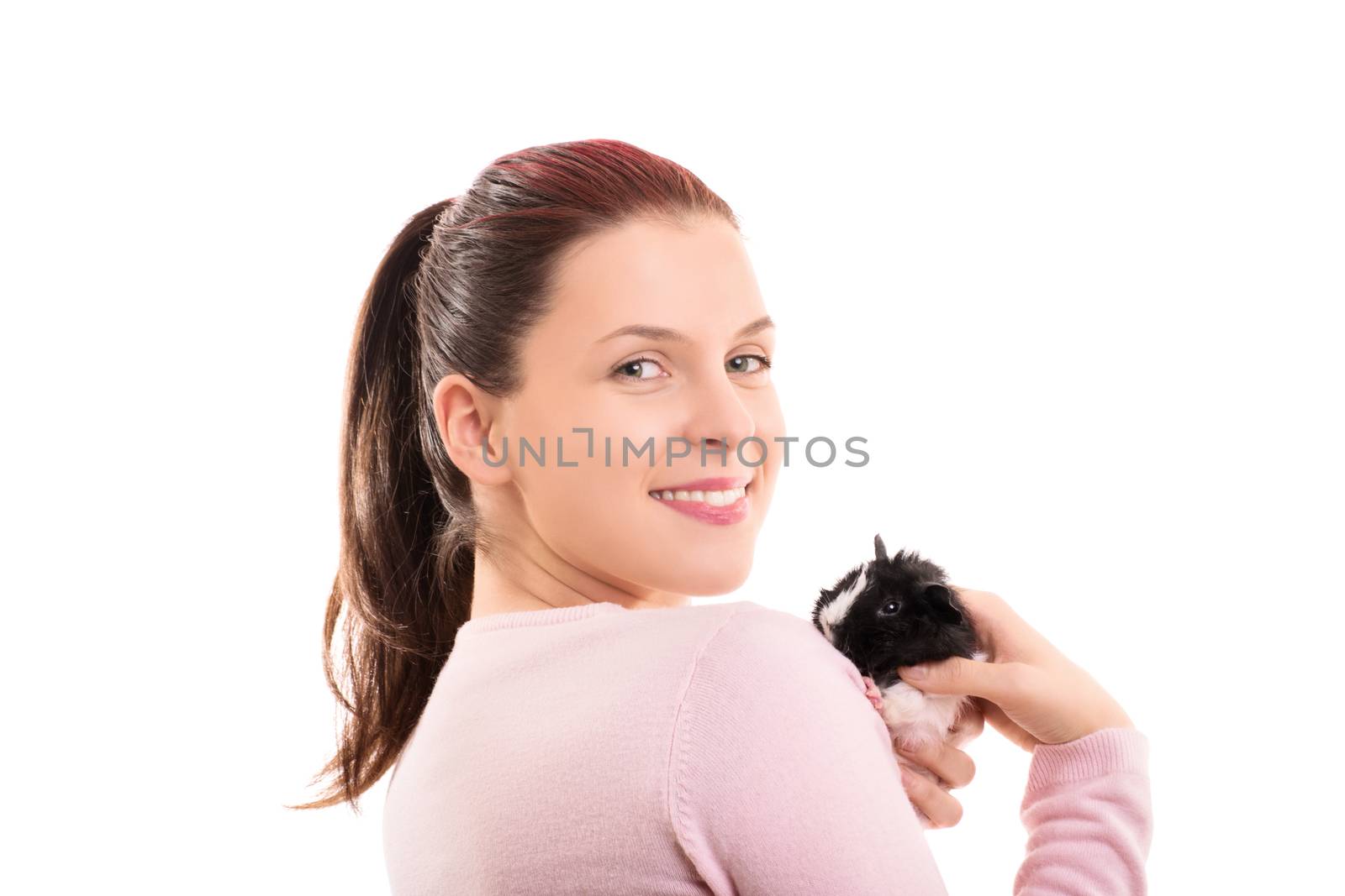 A portrait of a beautiful young girl holding her guinea pig, isolated on white background.