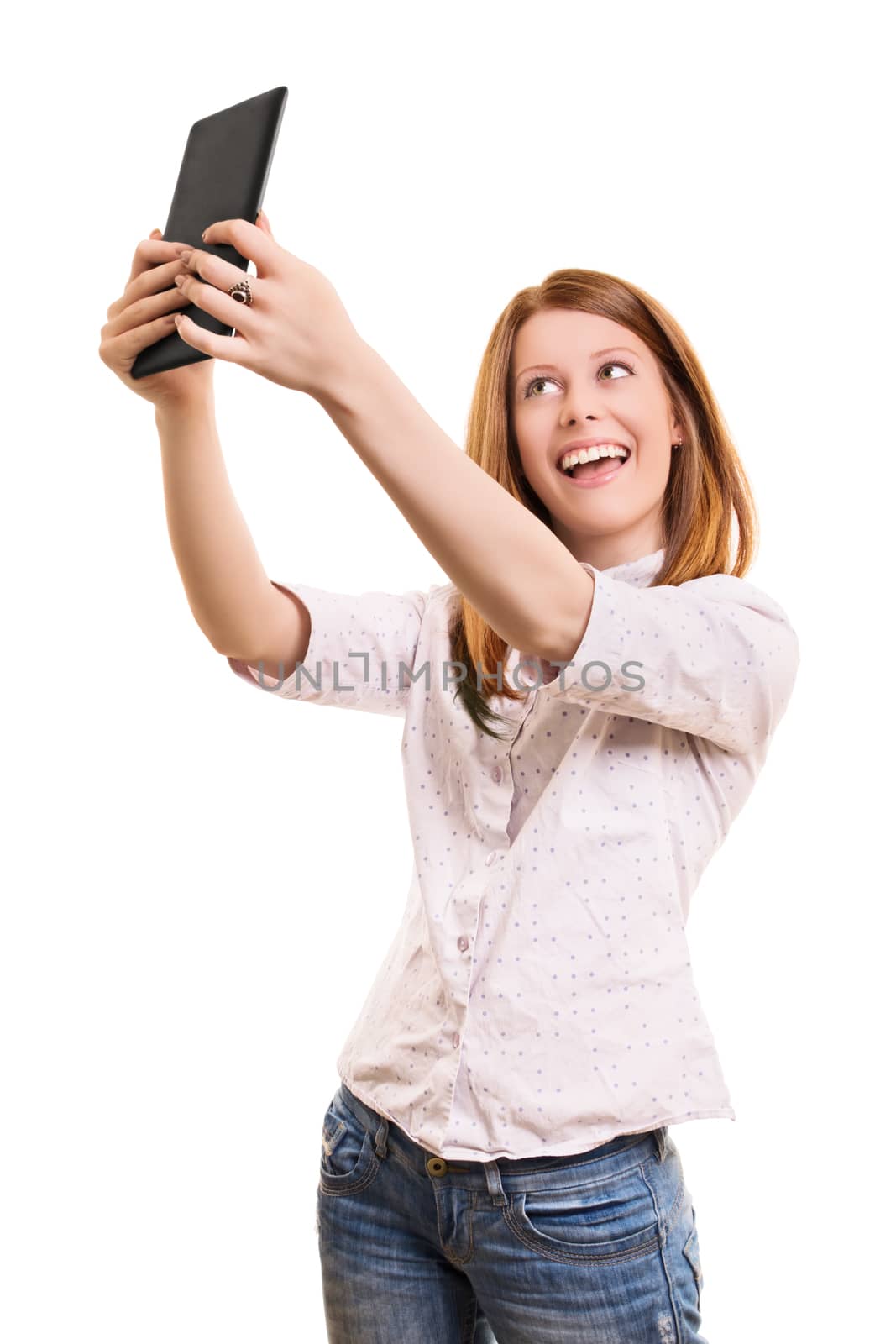 Smiling young girl taking a selfie with her tablet by Mendelex