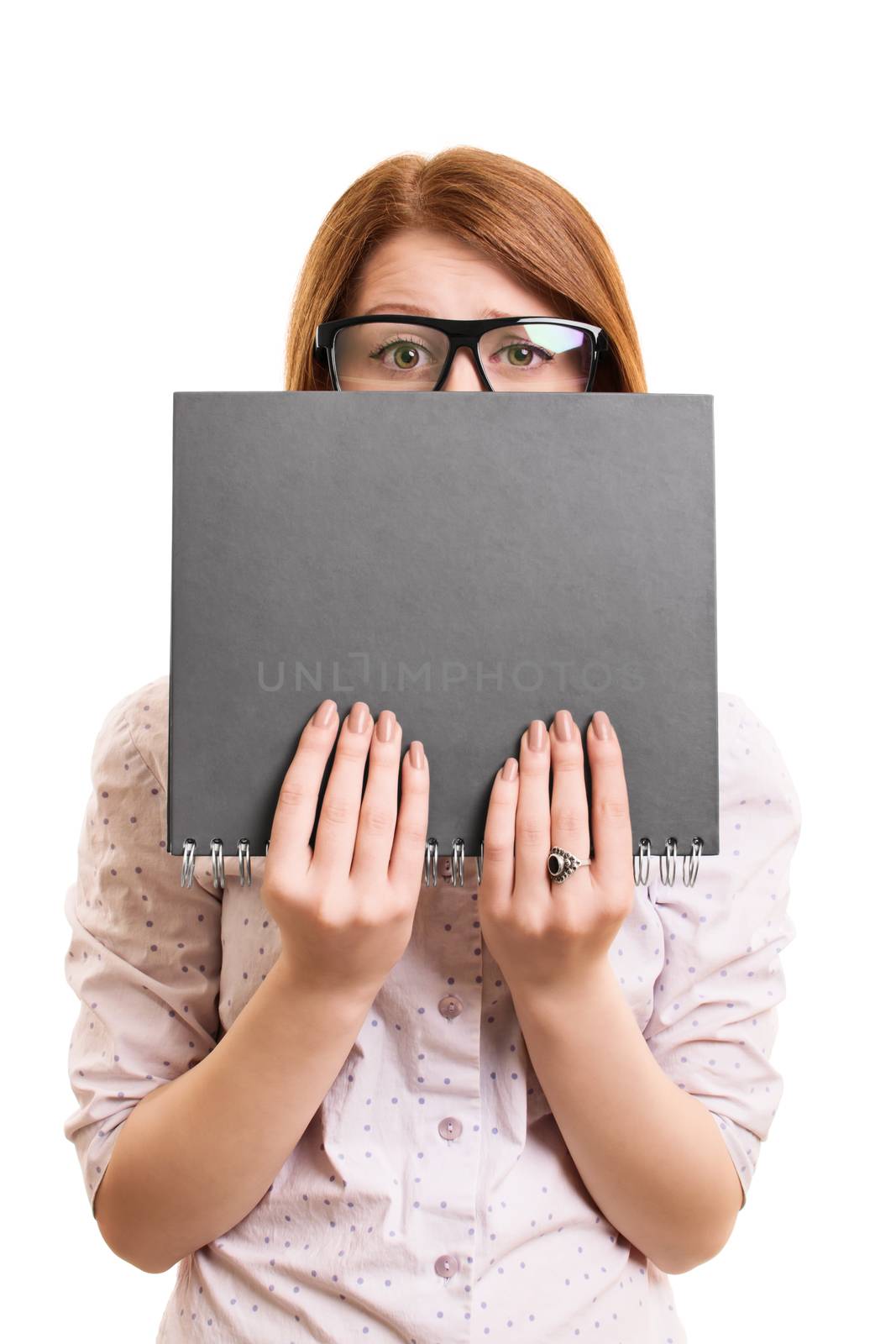Worried female student hiding behind a book by Mendelex