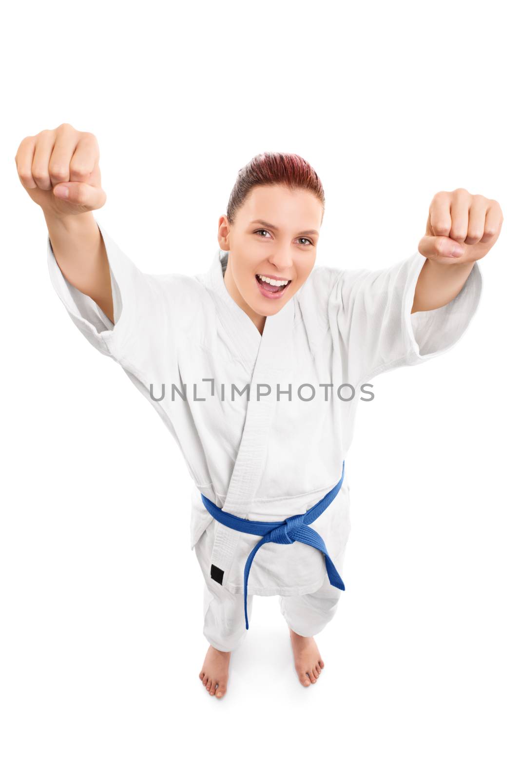 A portrait of a beautiful young girl in a kimono with blue belt cheering, from top perspective, isolated on white background.
