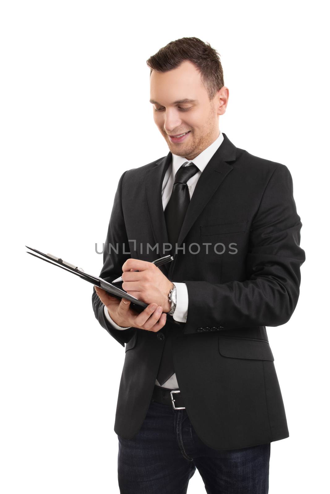 A portrait of a young businessman dressed in business casual clothes, writing on a clipboard, isolated on white background.

