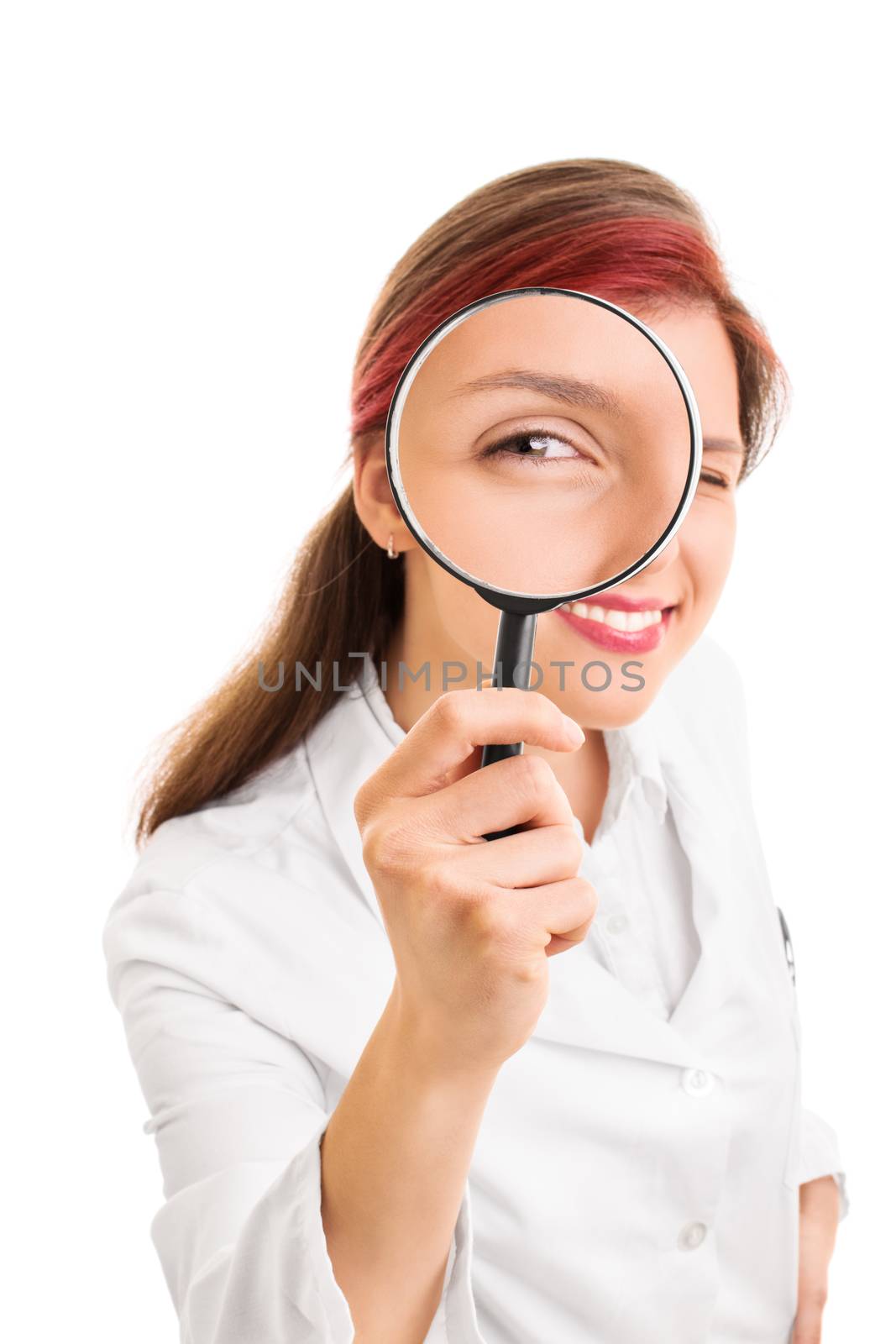 Let me take a look at you. Close up shot of a beautiful smiling young doctor looking though a magnifying glass, isolated on white background.