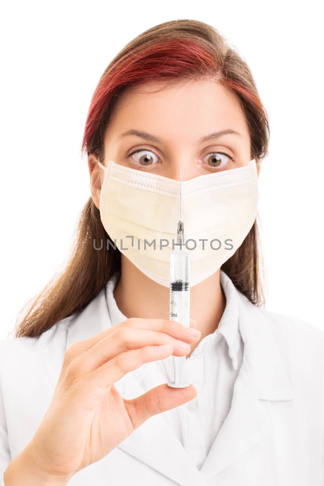 What do i do with this syringe? Young medical practitioner wearing a surgical mask, looking at a syringe with a needle, isolated on white background.