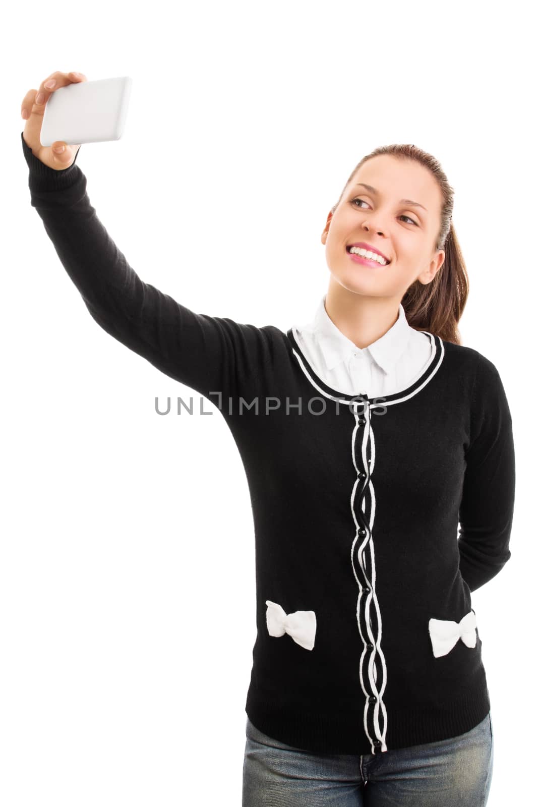 Young girl wearing school uniform and making a selfie, isolated on a white background.