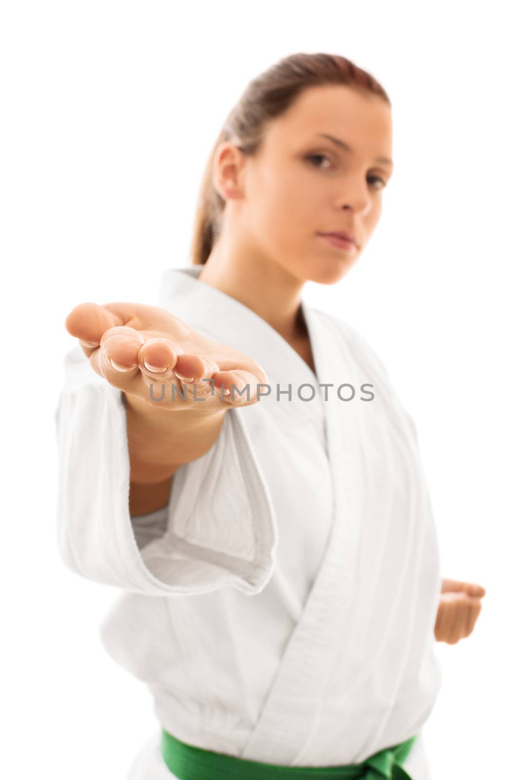 Bring it. Beautiful young girl in kimono with green belt taunting you, isolated on white background.