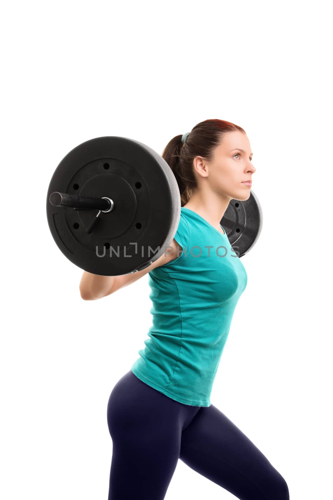Imagining and getting the perfect you. Beautiful young girl holding a barbell, isolated on white background. Ready for some squats.