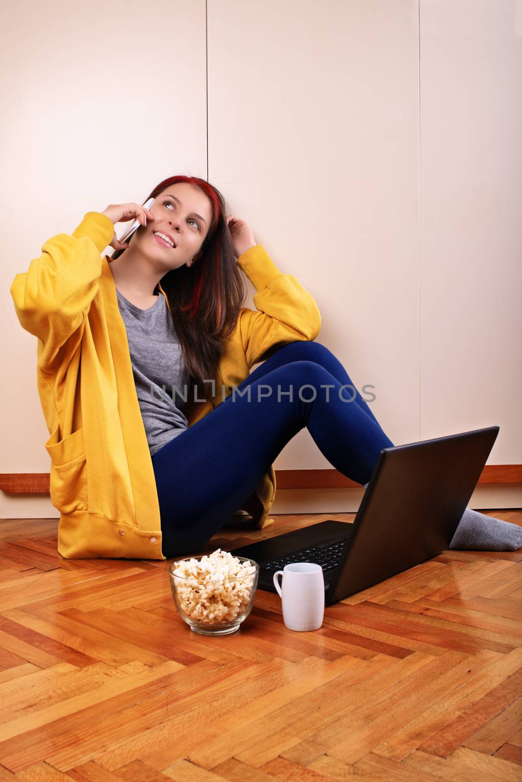 Young girl on her phone preparing to watch a movie by Mendelex