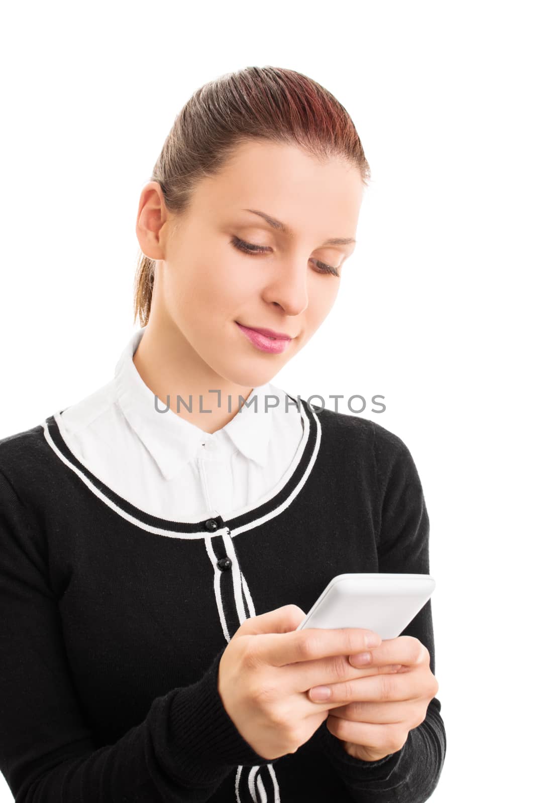 Checking phone. Close up of a young student girl looking at her phone, isolated on white background.