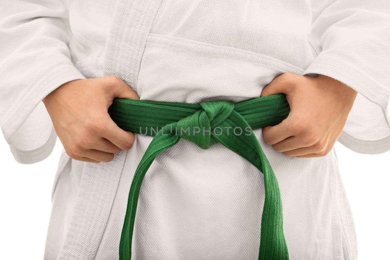 I'm combat ready. Close up shot of the mid section of a girl in kimono with green belt, isolated on white background.