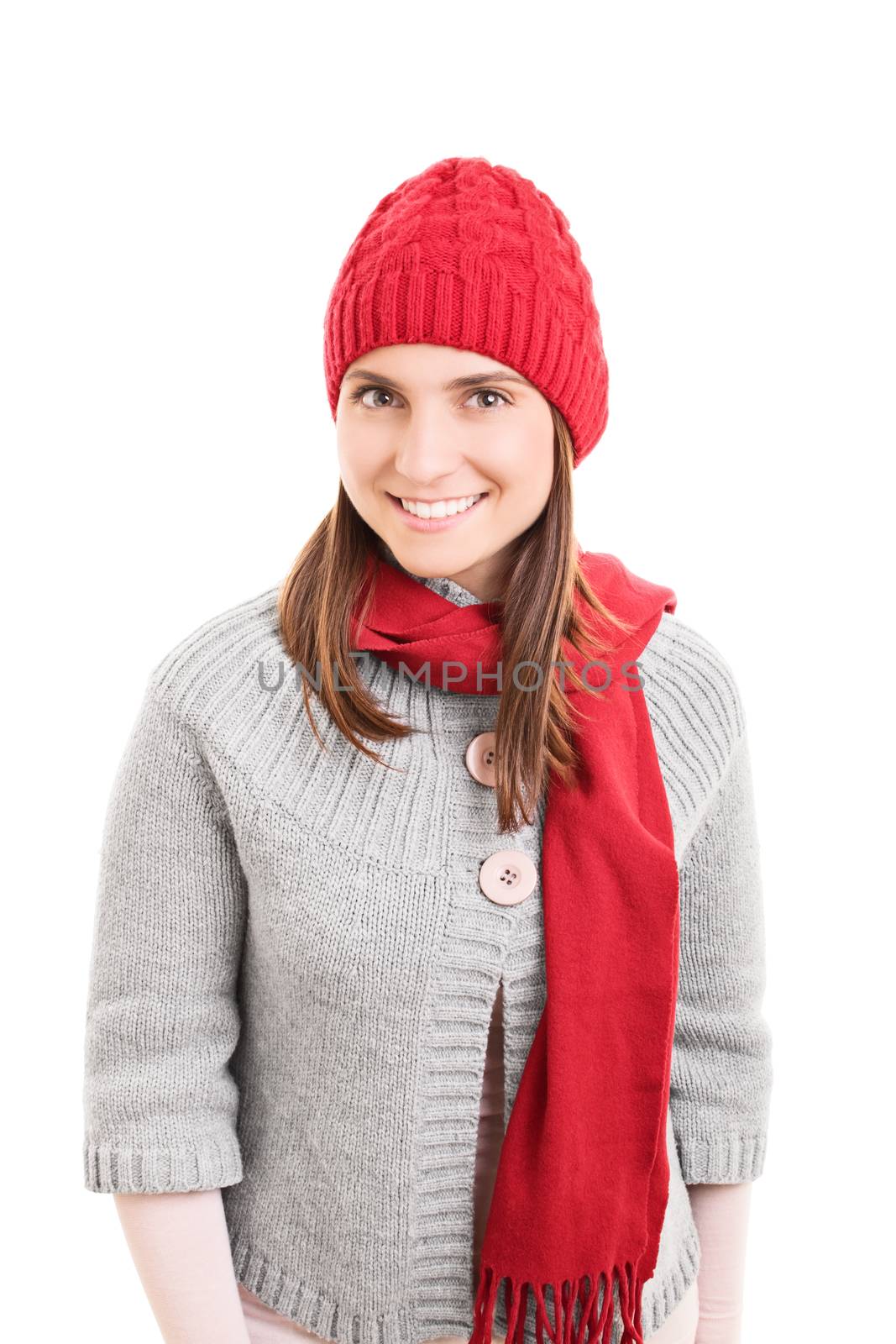 Portrait of a beautiful smiling young girl wearing warm red winter scarf and beanie, isolated on white background.