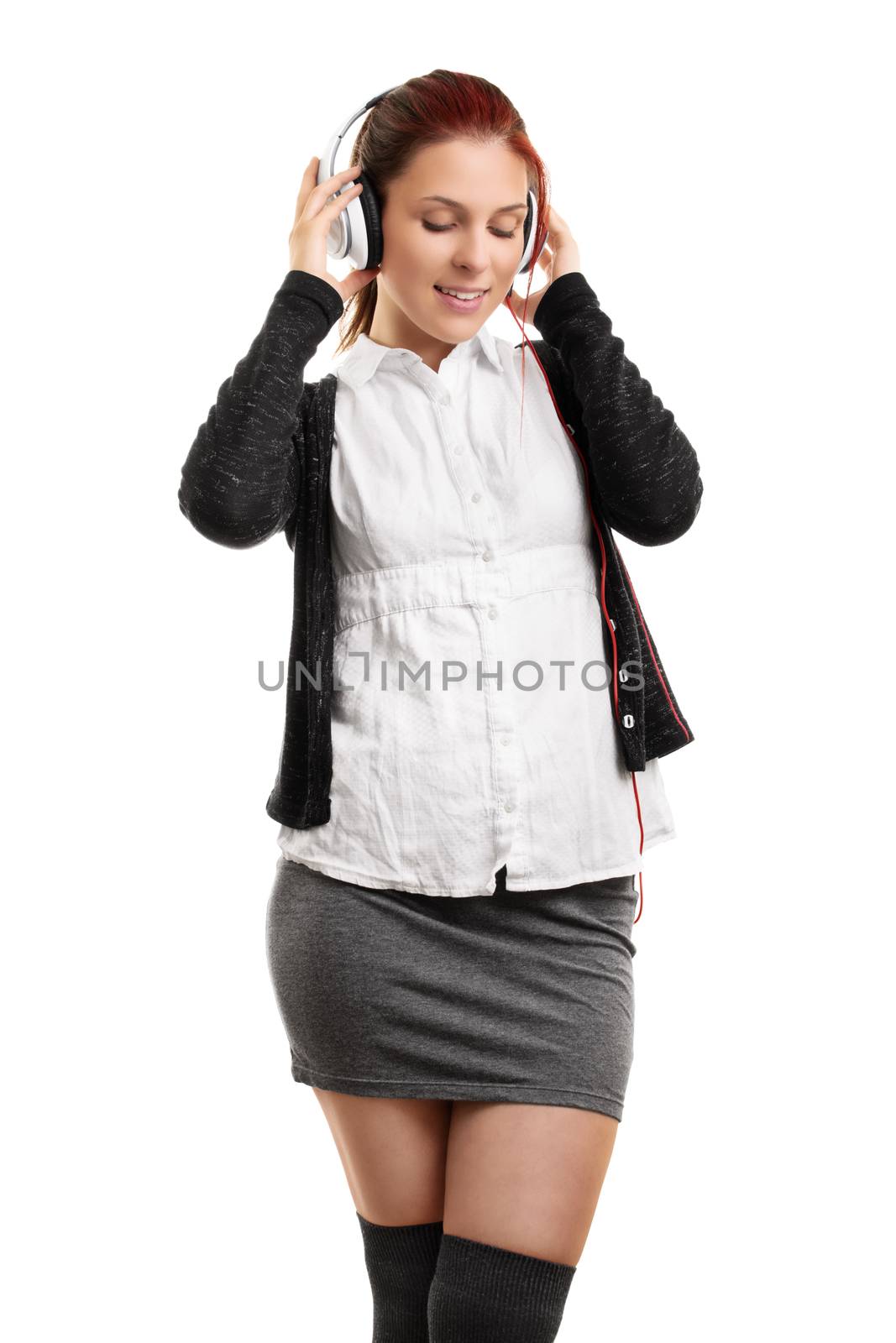 Young woman enjoying music on her headphones by Mendelex