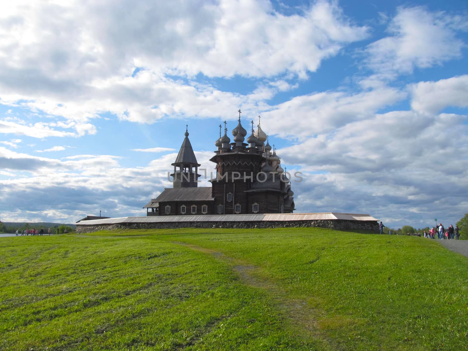 Old wooden Church in the summer against the sky with clouds. by Igor2006