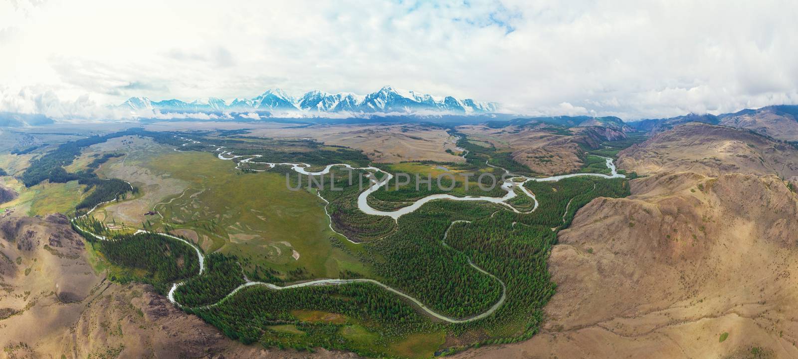 Kurai steppe and Chuya river on North-Chui ridge background. Altai mountains, Russia. Aerial drone panoramic picture.