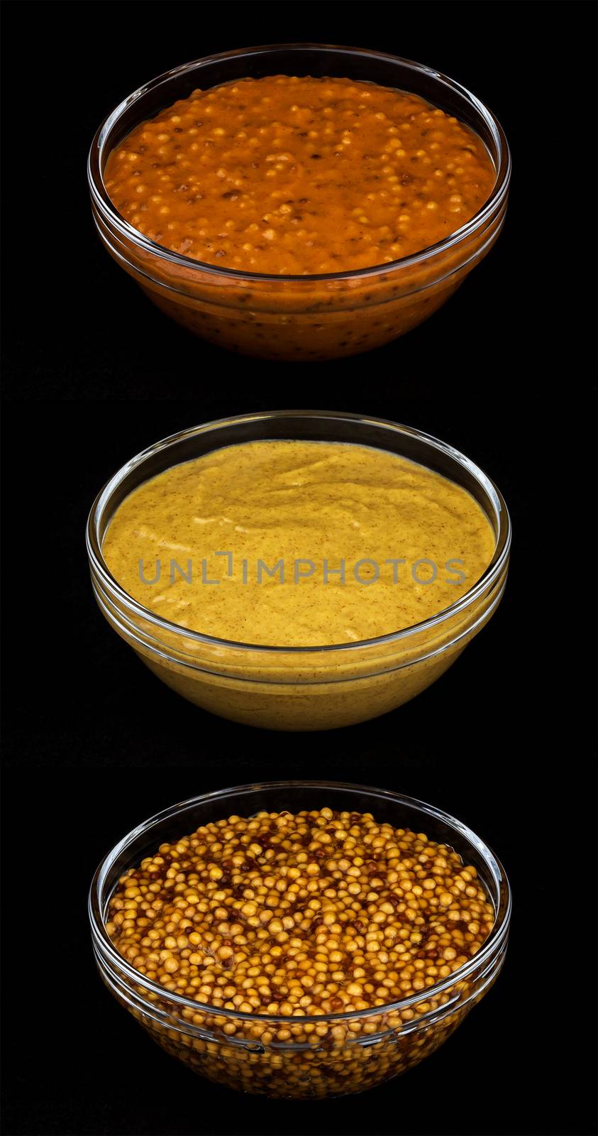 Set of various types of mustard on black background