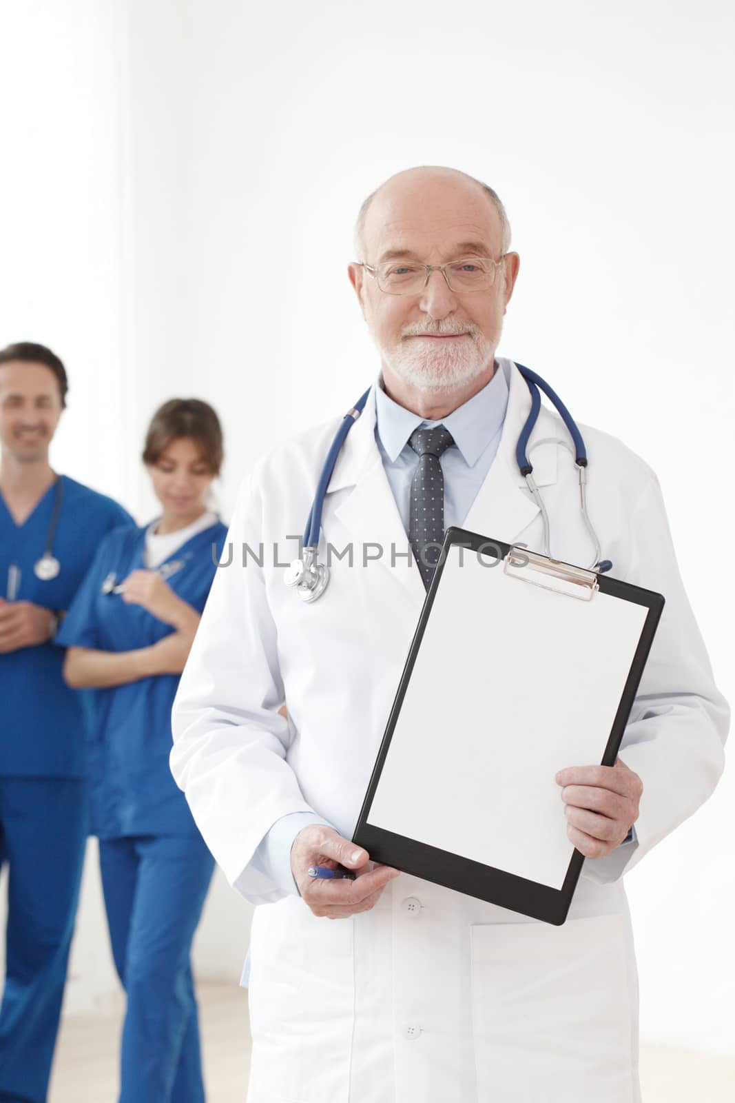 Smiling team of doctors and nurses on white background